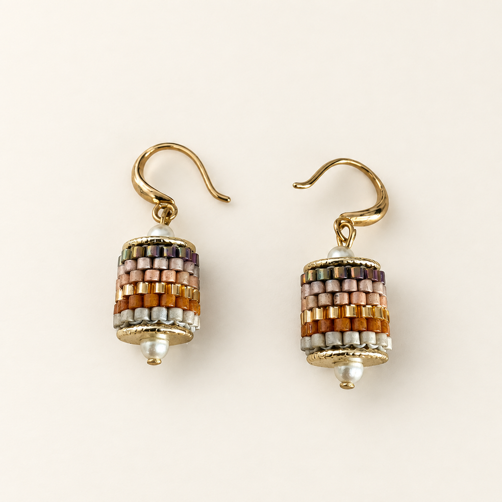 Pair of gold-toned beaded drop earrings in blush, amber, pale grey and iridescent tones on ivory