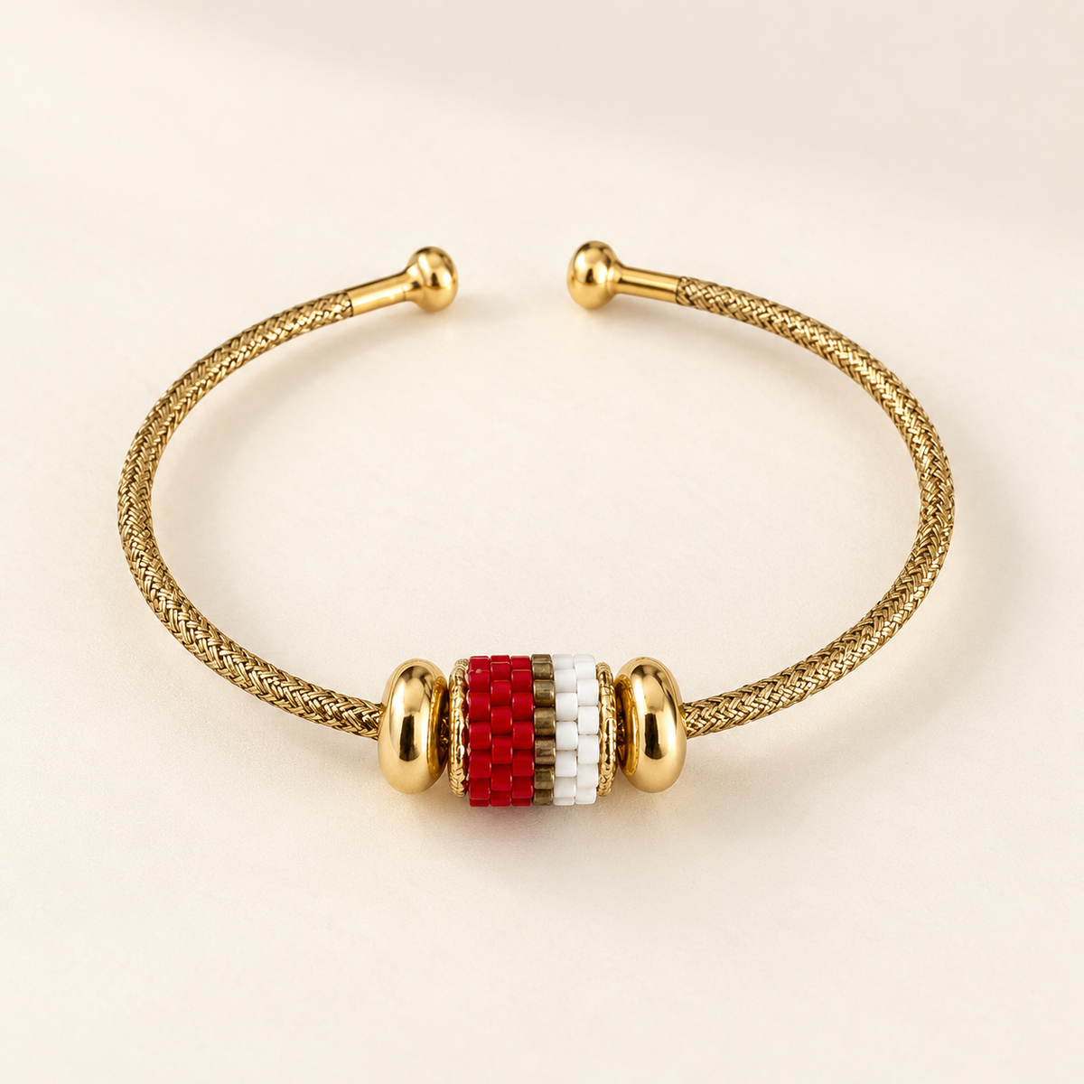 Gold-toned open cuff bracelet with scarlet, white and gold-toned striped beadwork