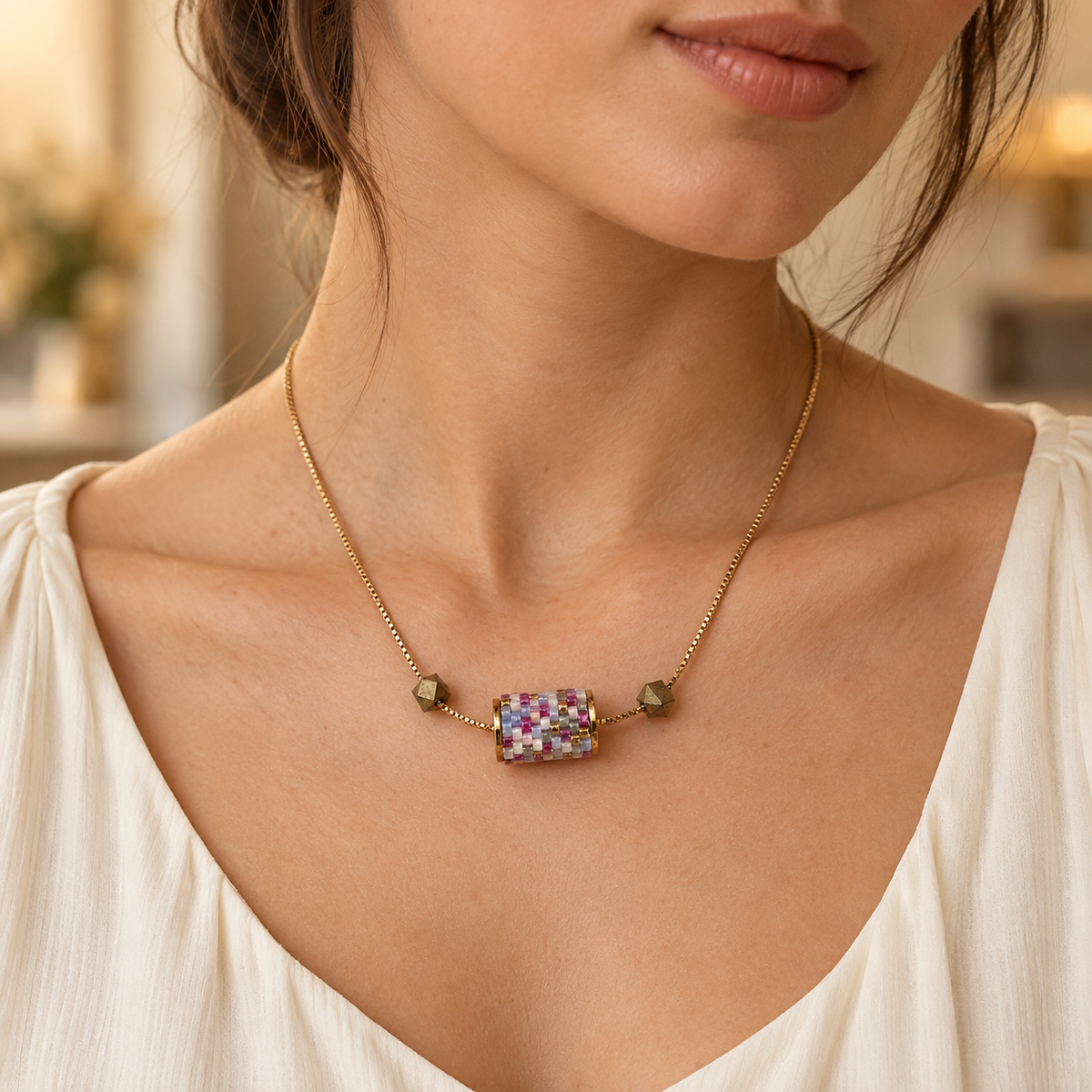 Gold-toned chain necklace with lavender, white, pale blue and pink beadwork — styled view