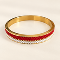 Gold-toned bangle with scarlet red and white beadwork and a fine gold-toned line